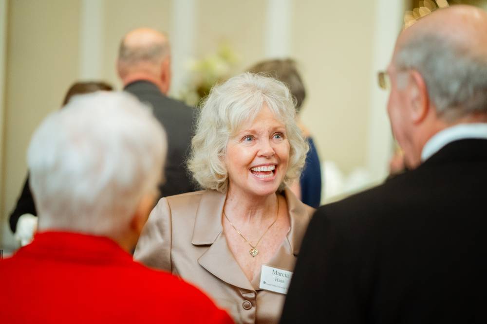 Marcia Haas talking with guests at the Foundation Holiday Reception